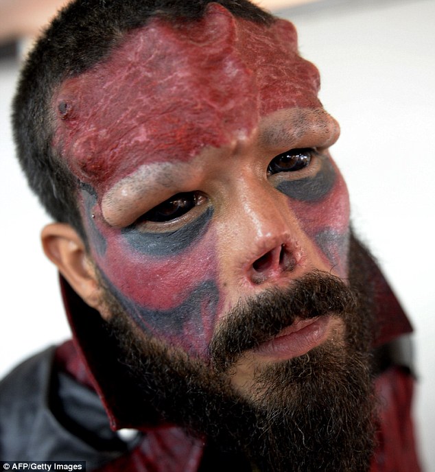 Real-life villain: Henry Damon, 37, from Caracas, Venezuela, has had his nose removed as part of his facial transformation into a real-life version of Marvel villain Red Skull