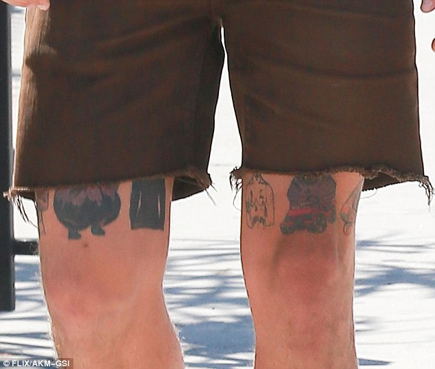 Body art: The 29-year-old actor showed off what appeared to be new tattoos above his knees