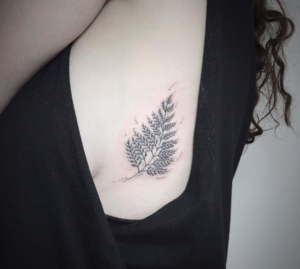 Elegantly designed fern on ribcage by Sarah Gaugler