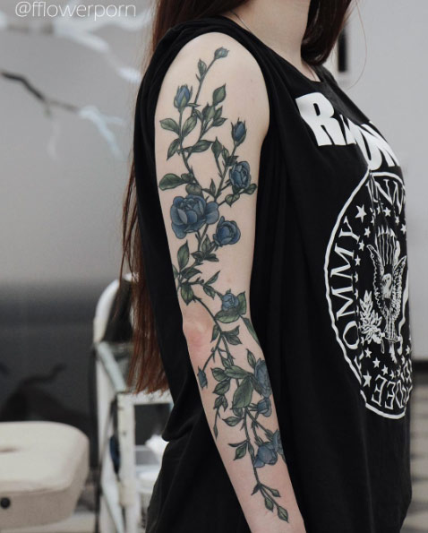 Botanical floral sleeve tattoo by Olga Nekrasova